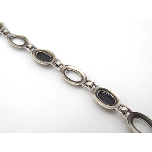 321 - A silver bracelet set with onyx and marcasite