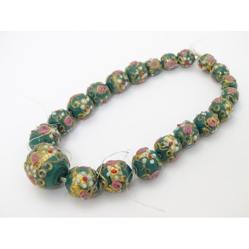 326 - 21 graduated Venetian glass beads with hand painted decoration. The largest approx ½'' diameter