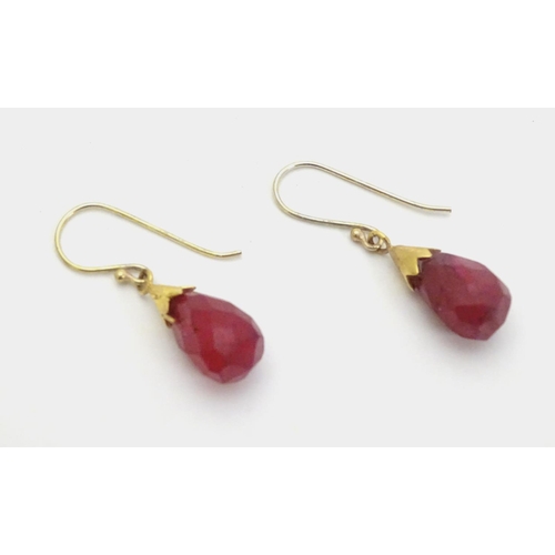 327 - A pair of gilt metal drop earrings set with facet cut red stones 1 1/4'' long