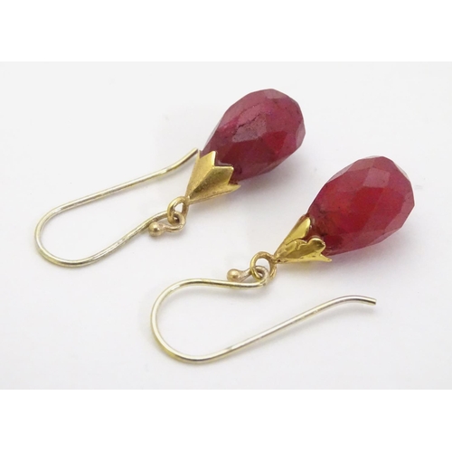 327 - A pair of gilt metal drop earrings set with facet cut red stones 1 1/4'' long