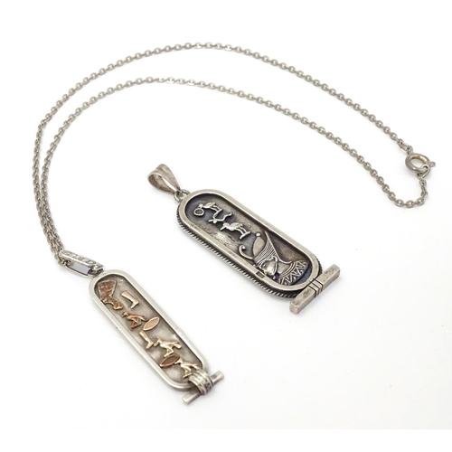 334 - Egyptian Revival Jewellery: 2 Egyptian silver pendants decorated with Egyptian imagery / hieroglyphi... 