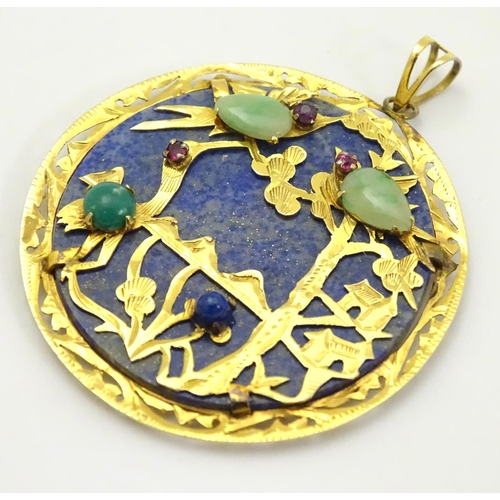 336 - An Oriental lapiz lazuli pendant set with jade, ruby, amethyst within a 14k gold mount. 1 3/4'' diam... 