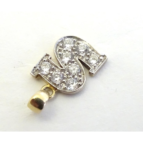 344 - A 9ct gold pendant  / charm formed as the letter 'S' and profusely set with white stones ½'' long