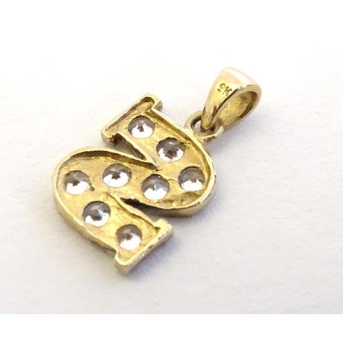 344 - A 9ct gold pendant  / charm formed as the letter 'S' and profusely set with white stones ½'' long