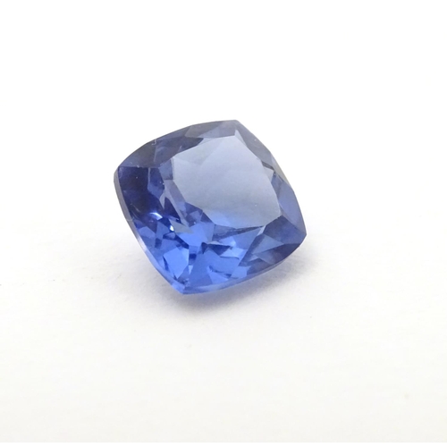 347 - Unmounted stone: A blue cushion cut tanzanite, approx 8.10 ct, approx 3/8'' wide