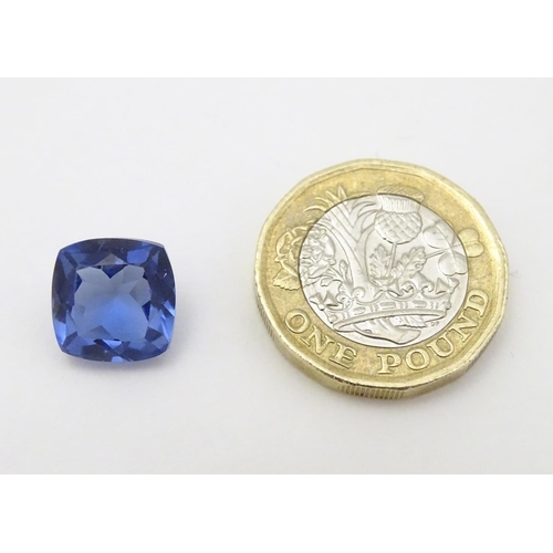 347 - Unmounted stone: A blue cushion cut tanzanite, approx 8.10 ct, approx 3/8'' wide