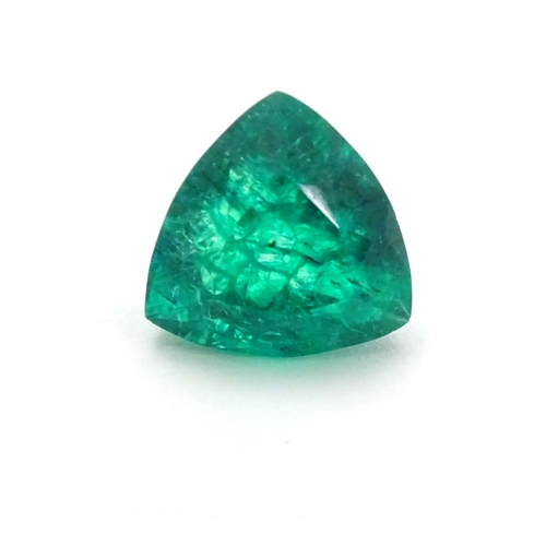 348 - Unmounted stone: A green trillion cut emerald. approx 6.90 ct, approx 3/8'' wide