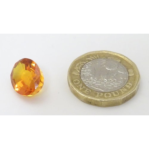 352 - Unmounted stone: An orange oval cut sapphire, approx 9.80 ct, approx ½'' long