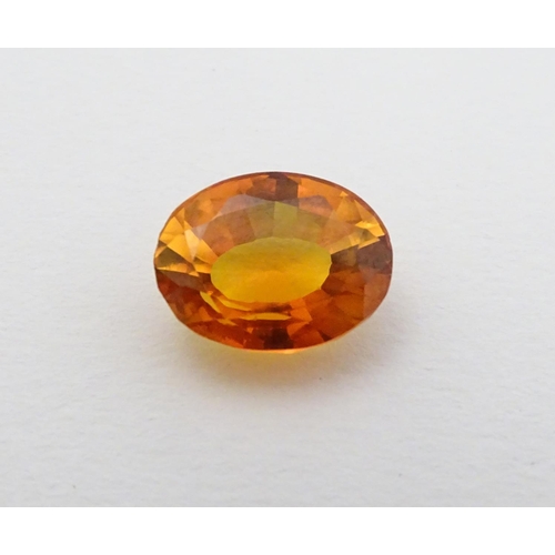 352 - Unmounted stone: An orange oval cut sapphire, approx 9.80 ct, approx ½'' long