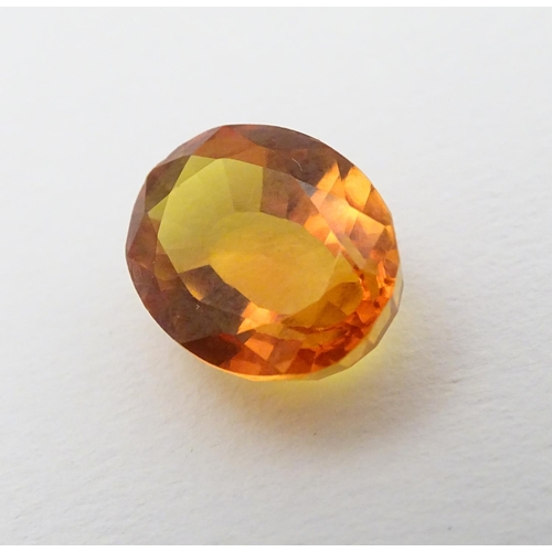 352 - Unmounted stone: An orange oval cut sapphire, approx 9.80 ct, approx ½'' long