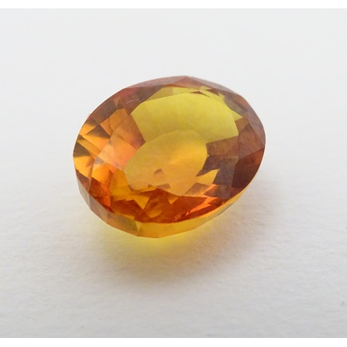 352 - Unmounted stone: An orange oval cut sapphire, approx 9.80 ct, approx ½'' long