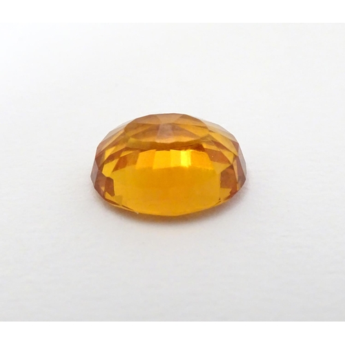 352 - Unmounted stone: An orange oval cut sapphire, approx 9.80 ct, approx ½'' long