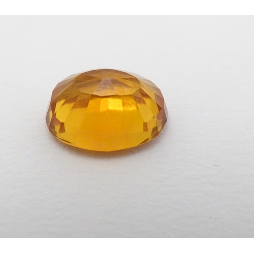 352 - Unmounted stone: An orange oval cut sapphire, approx 9.80 ct, approx ½'' long