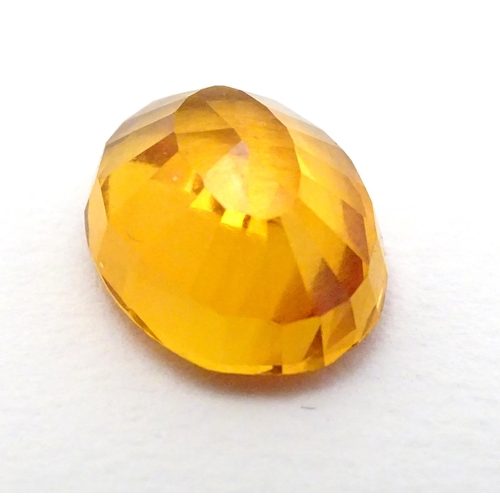 352 - Unmounted stone: An orange oval cut sapphire, approx 9.80 ct, approx ½'' long