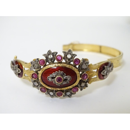 358 - A charming 18ct gold bangle bracelet set with diamonds and rubies and with red guilloché enamelling