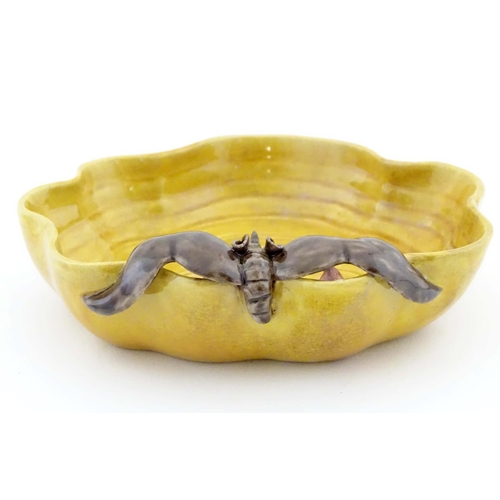 36 - A Chinese wavy edged yellow brush wash dish with bat and fruit decoration, Chinese character marks t... 