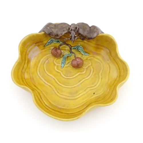 36 - A Chinese wavy edged yellow brush wash dish with bat and fruit decoration, Chinese character marks t... 