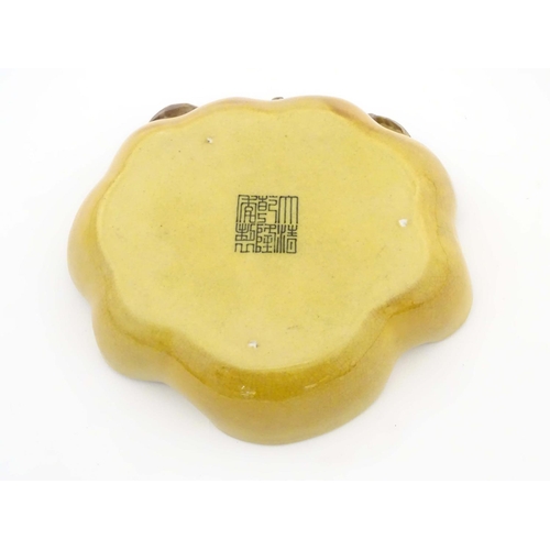 36 - A Chinese wavy edged yellow brush wash dish with bat and fruit decoration, Chinese character marks t... 