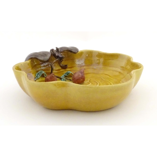 36 - A Chinese wavy edged yellow brush wash dish with bat and fruit decoration, Chinese character marks t... 