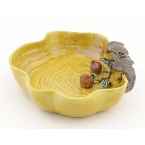 36 - A Chinese wavy edged yellow brush wash dish with bat and fruit decoration, Chinese character marks t... 