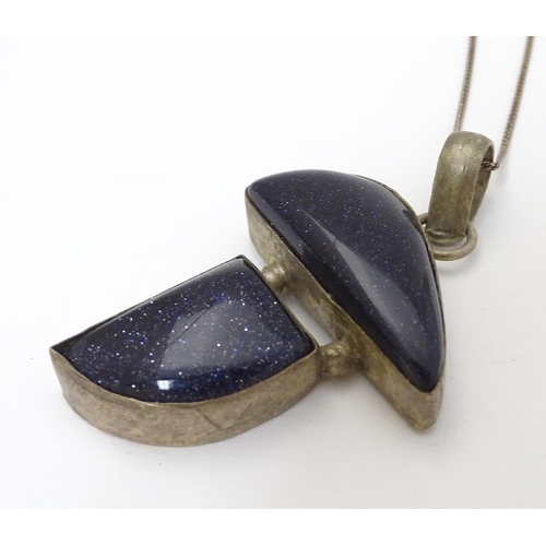 361 - A modernist pendant set with polished hardstone detail 2'' long with a 16'' silver chain.