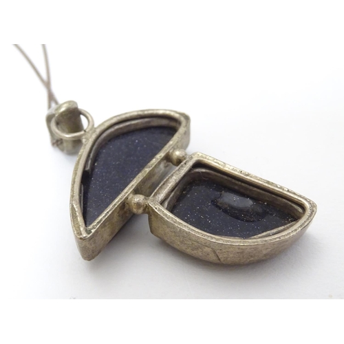 361 - A modernist pendant set with polished hardstone detail 2'' long with a 16'' silver chain.