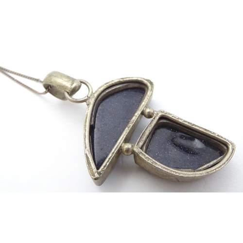 361 - A modernist pendant set with polished hardstone detail 2'' long with a 16'' silver chain.