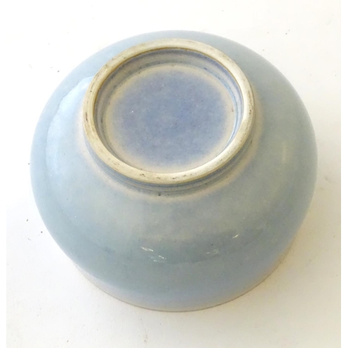 37 - An unmarked high fired blue glazed bowl. Approx. 3'' high.