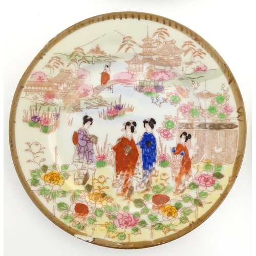 38 - Six Japanese plates depicting figures in traditional dress in an Oriental landscape depicting Mount ... 