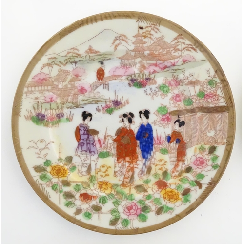 38 - Six Japanese plates depicting figures in traditional dress in an Oriental landscape depicting Mount ... 