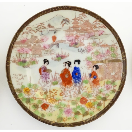 38 - Six Japanese plates depicting figures in traditional dress in an Oriental landscape depicting Mount ... 