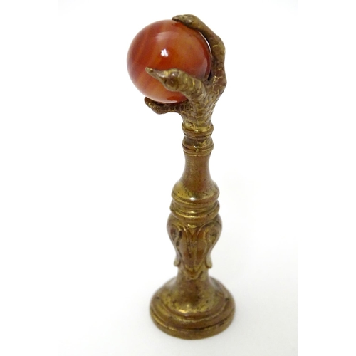 383 - A hand seal, the handle formed as a birds claw holding an agate sphere 2 1/2'' high