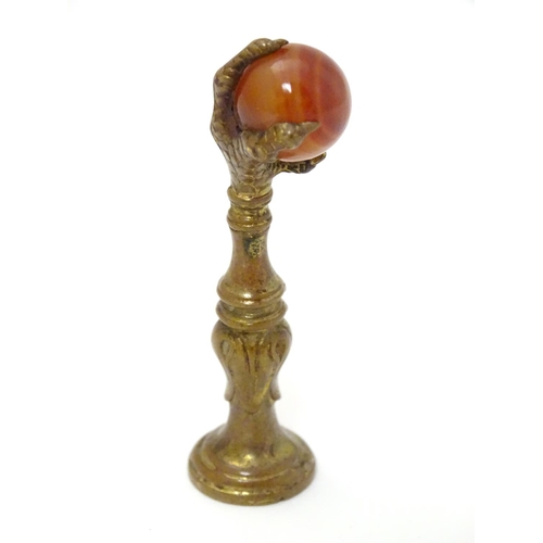 383 - A hand seal, the handle formed as a birds claw holding an agate sphere 2 1/2'' high