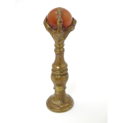 383 - A hand seal, the handle formed as a birds claw holding an agate sphere 2 1/2'' high