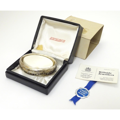 389 - A silver bangle bracelet hallmarked Birmingham 1970 . In original Excalibur box