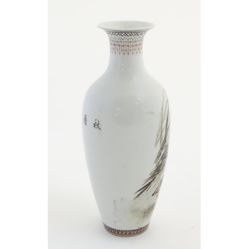 39 - A small Oriental baluster vase, decorated with wader birds in reeds, with calligraphy to the reverse... 