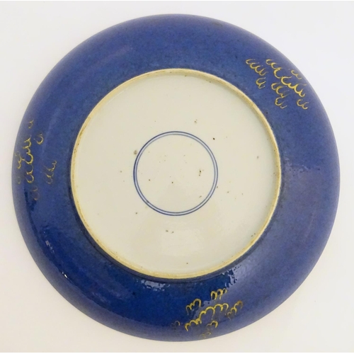 4 - A Chinese dish decorated with a gilt dragon on a blue ground. Approx. 10 1/4'' diameter.