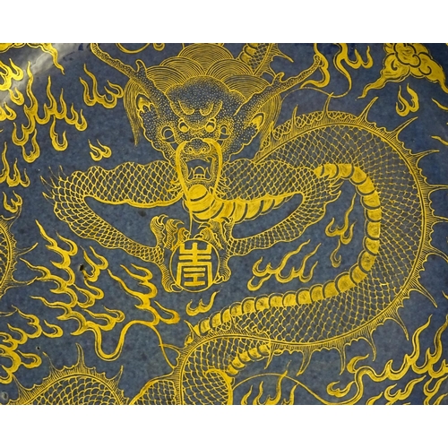 4 - A Chinese dish decorated with a gilt dragon on a blue ground. Approx. 10 1/4'' diameter.