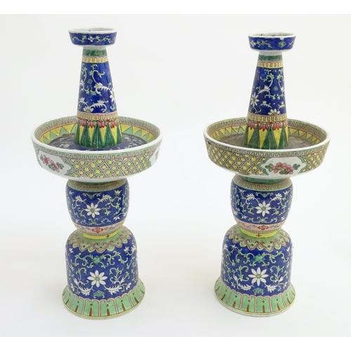 40 - A pair of two-sectional Chinese vases decorated with floral and foliate scrolls. Approx. 17 ¾'' high... 