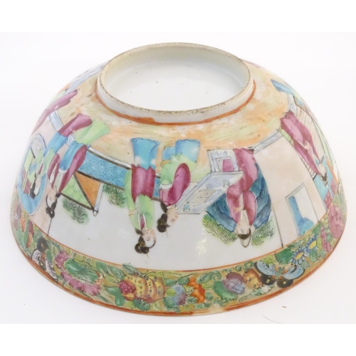 41 - A Cantonese famille rose bowl with panelled decoration depicting figures in traditional dress in var... 