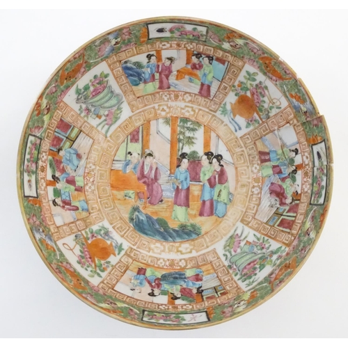 41 - A Cantonese famille rose bowl with panelled decoration depicting figures in traditional dress in var... 