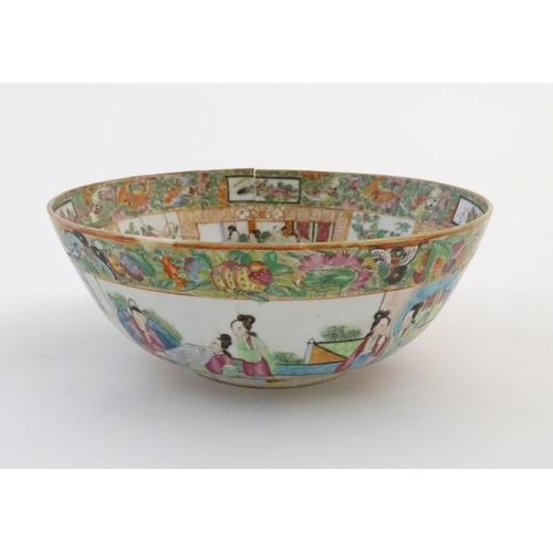 41 - A Cantonese famille rose bowl with panelled decoration depicting figures in traditional dress in var... 