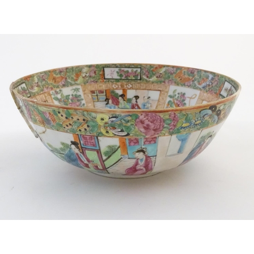 41 - A Cantonese famille rose bowl with panelled decoration depicting figures in traditional dress in var... 