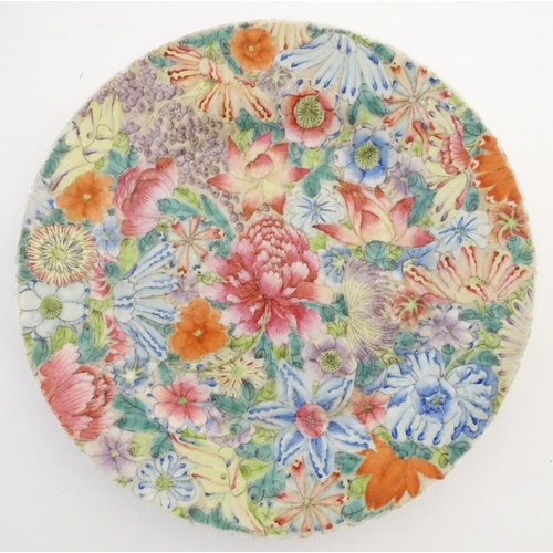 44 - An Oriental plate decorated with stylised flowers, with a scrolling floral design to reverse. Charac... 