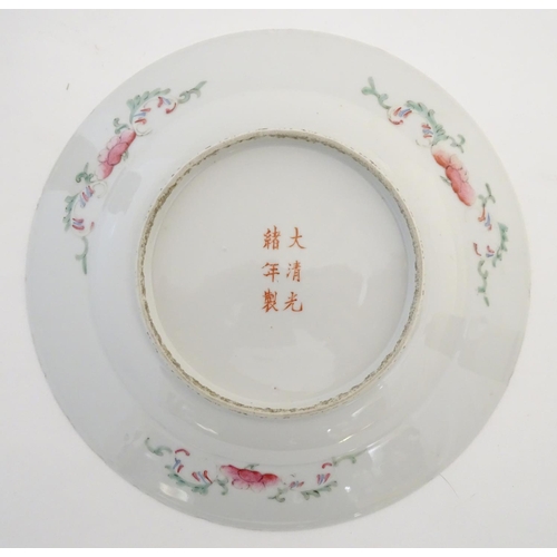 44 - An Oriental plate decorated with stylised flowers, with a scrolling floral design to reverse. Charac... 