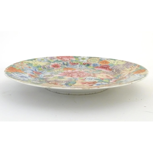 44 - An Oriental plate decorated with stylised flowers, with a scrolling floral design to reverse. Charac... 