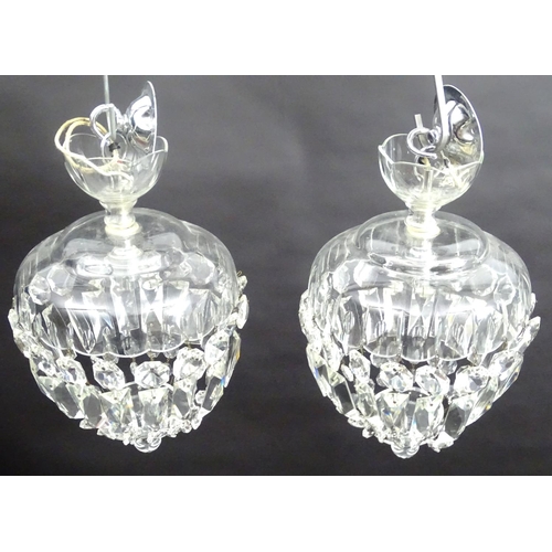 442 - A pair of crystal facet cut glass electric and chrome pendant light fittings, 7 1/2'' wide x 12'' hi... 