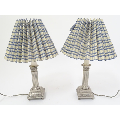 445 - Table Lamps: a pair of silver plate electric lamps formed as Corinthian column candle sticks with sq... 