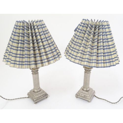 445 - Table Lamps: a pair of silver plate electric lamps formed as Corinthian column candle sticks with sq... 