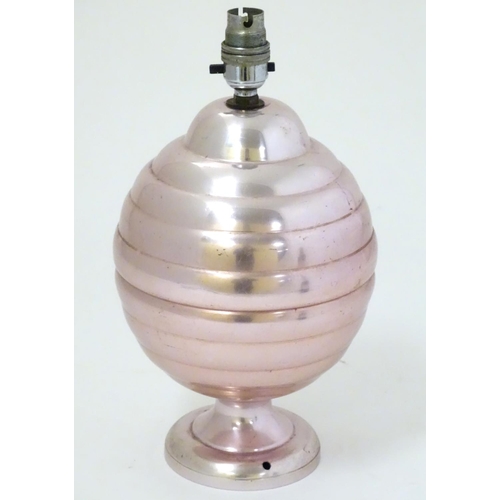 448 - A 1960s lamp of anodised aluminium with a pink/bright copper colour finish, 12 1/2'' high.